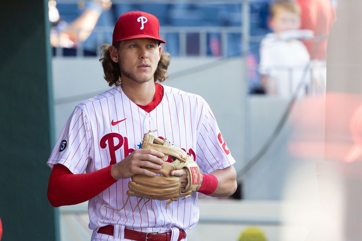 Alec Bohm stands in the dugout for the Philadelphia Phillies.