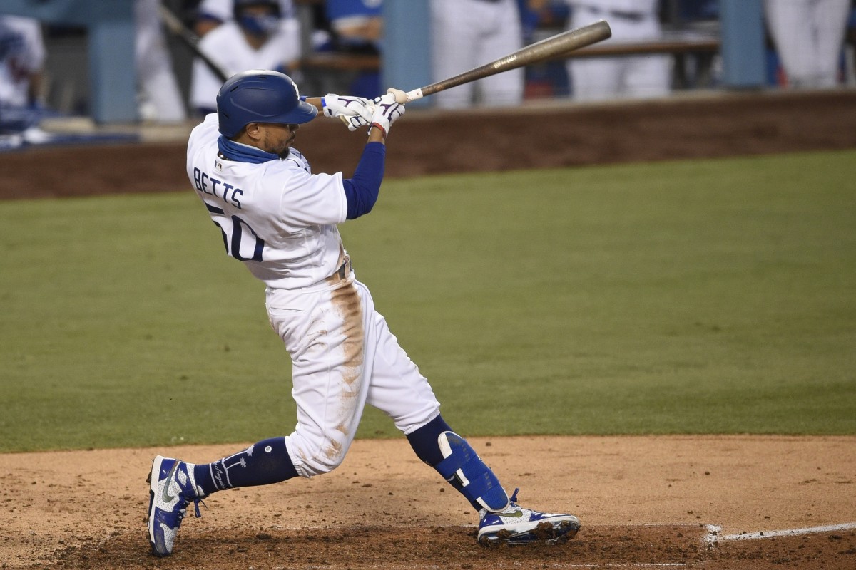 Mookie Betts swings while playing for the Los Angeles Dodgers.