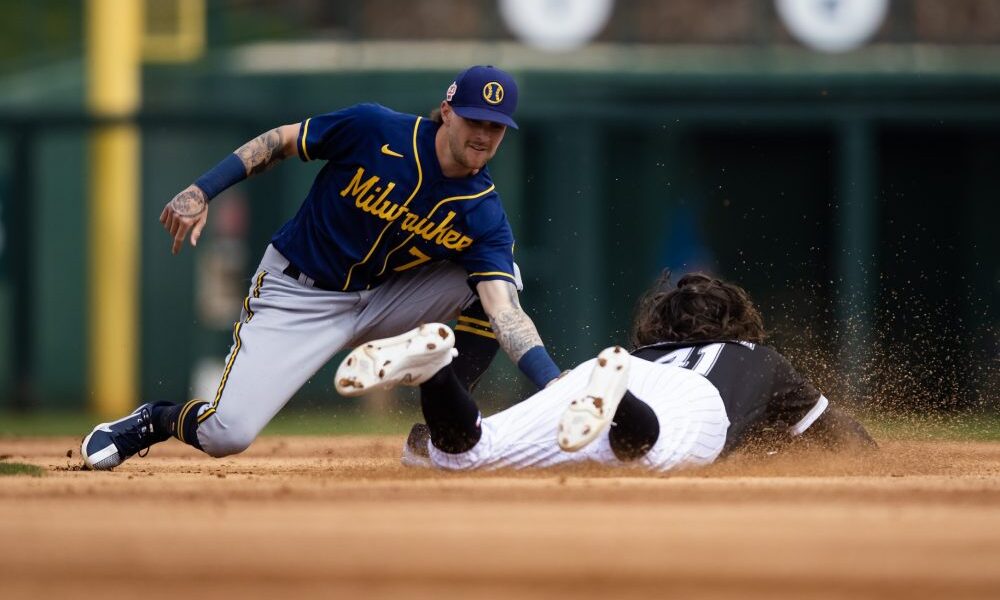 Brice Turang tags a runner at second base for the Milwaukee Brewers.